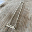 Close-up detail of VOTE bar choker showing hand-stamped lettering on vintage silverware, sits at collarbone, 6.5-inch drop