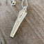 Close-up detail of VOTE bar pendant showing hand-stamped lettering on vintage 1923 Duchess pattern silverware, minimalist  design, 18-inch chain