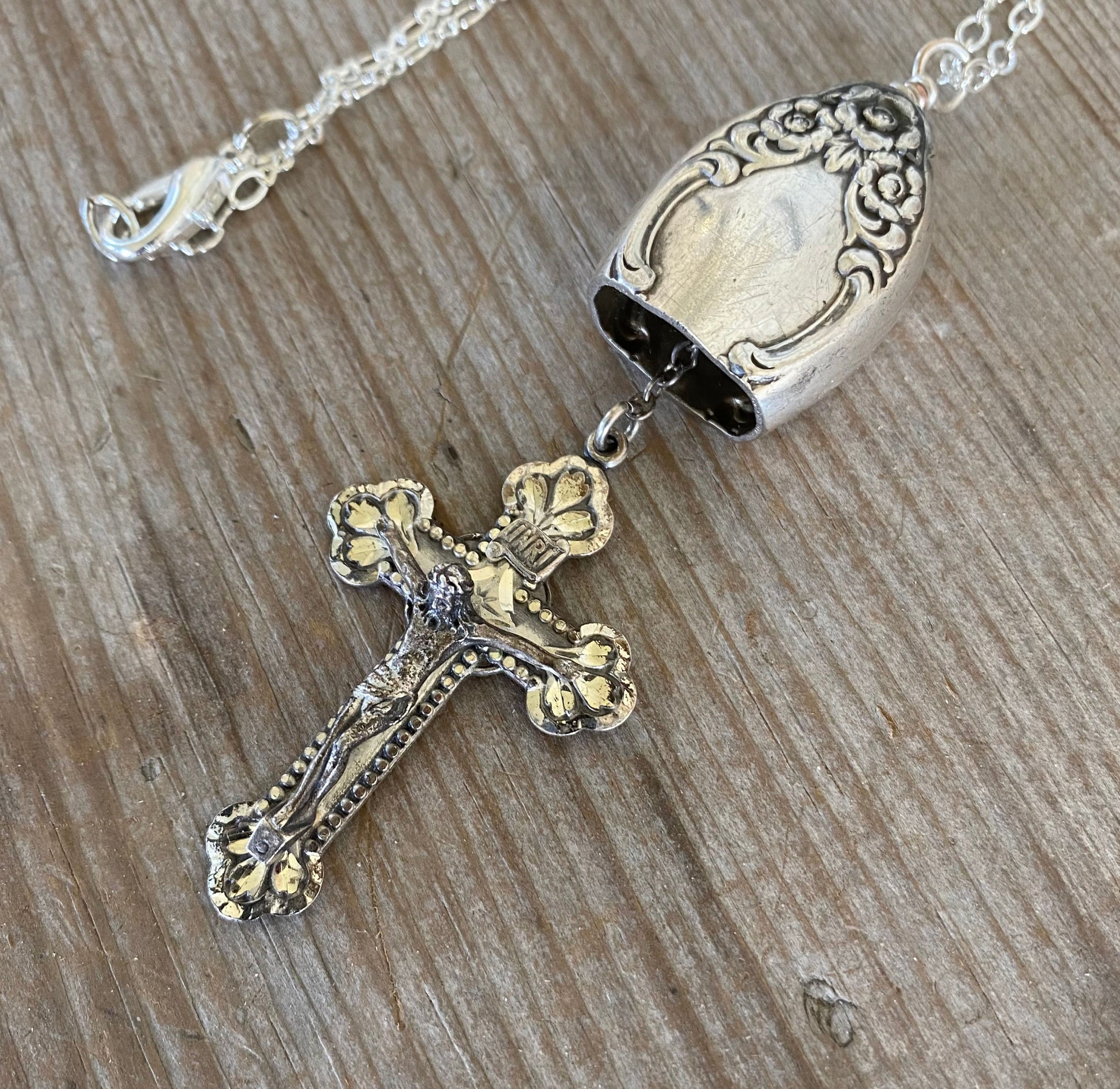 Vintage sterling silver rosary cross hanging as clapper inside upcycled knife bell pendant