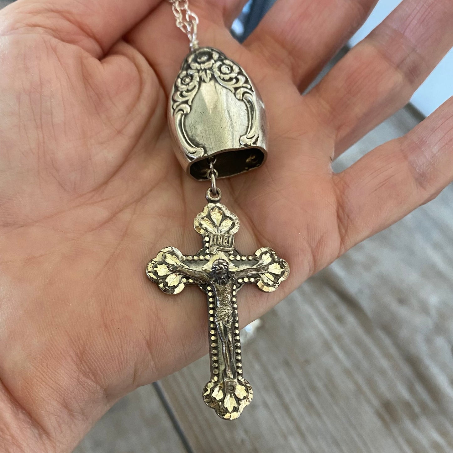 Close-up of crown-of-flowers detail on knife bell pendant made from vintage hollow-handle silverware