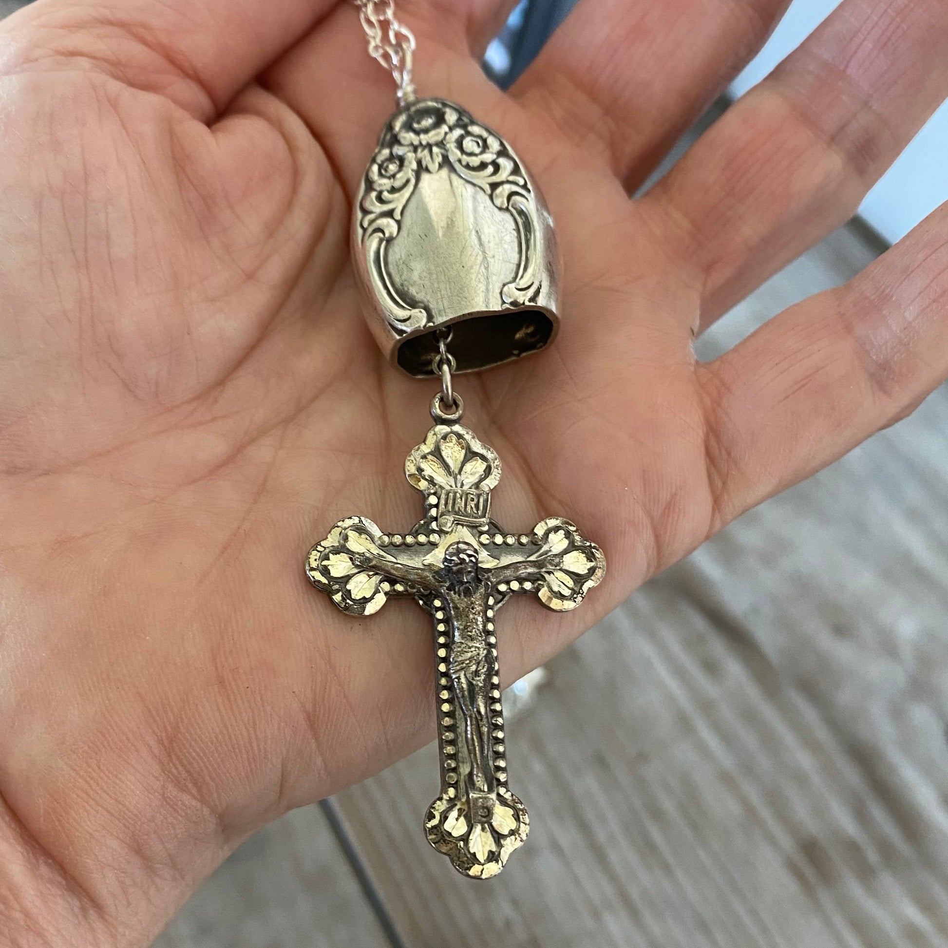 Close-up of crown-of-flowers detail on knife bell pendant made from vintage hollow-handle silverware