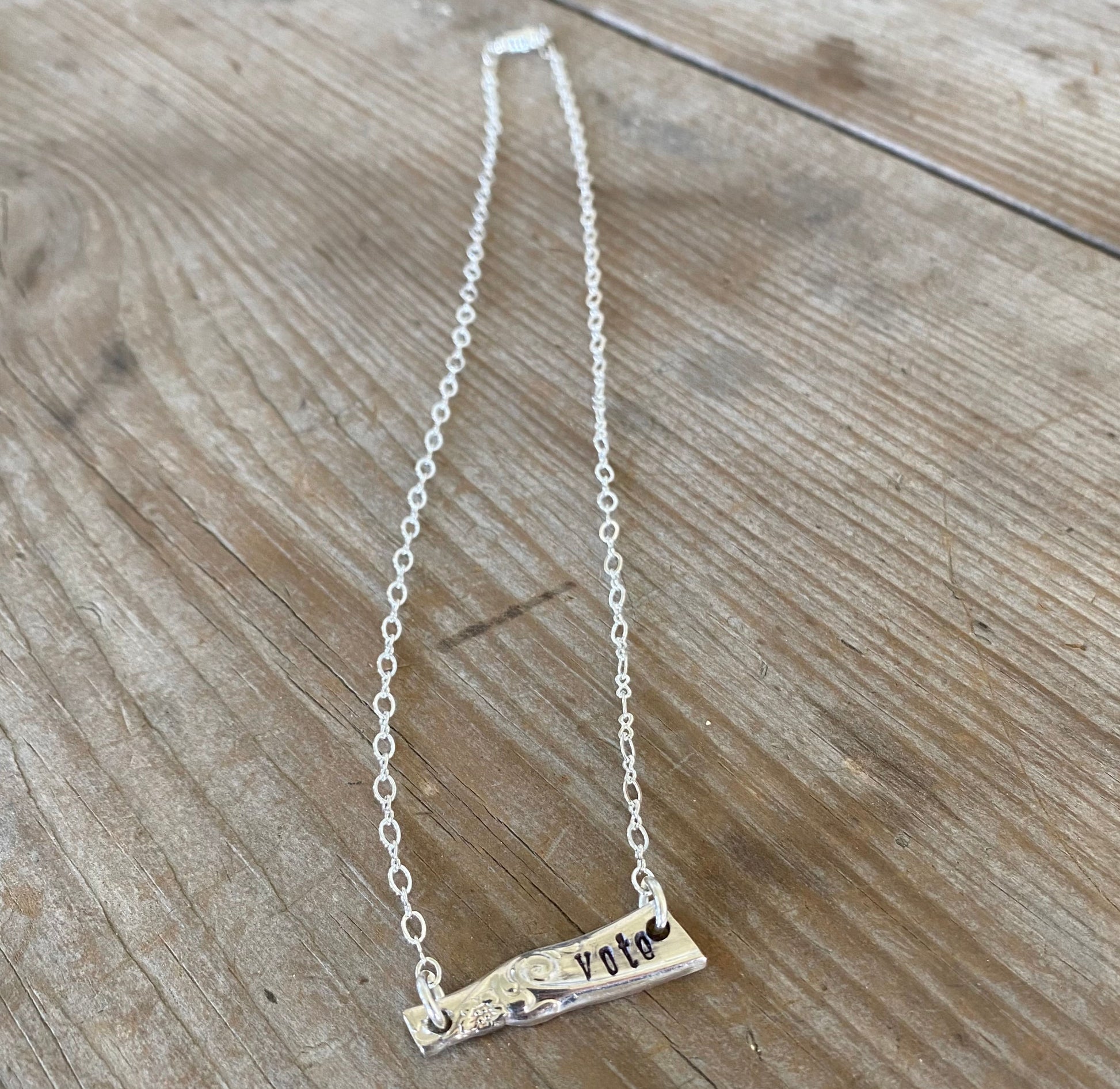 Handcrafted VOTE bar necklace hand-stamped on upcycled vintage silverplate with typewriter-style font, eco-friendly jewelry