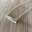 Close-up detail of VOTE bar pendant showing hand-stamped lettering on vintage silverware, 1.25 inches wide