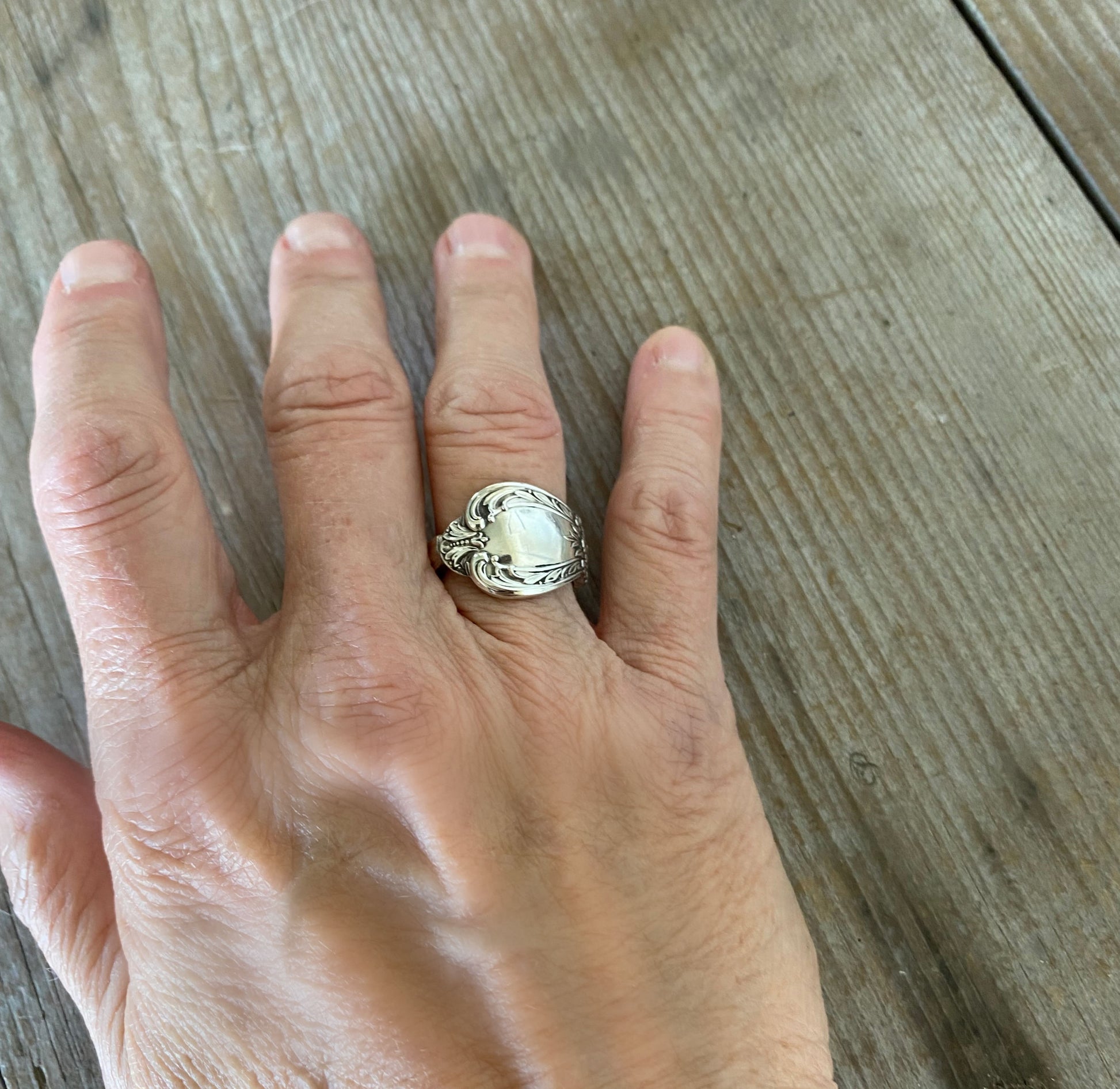 Spoon ring hand made from vintage spoon handle shown on model's hand