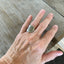 Shell spoon ring worn on finger displaying size and fit of upcycled silverware ring