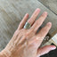 Shell spoon ring worn on finger displaying size and fit of upcycled silverware ring