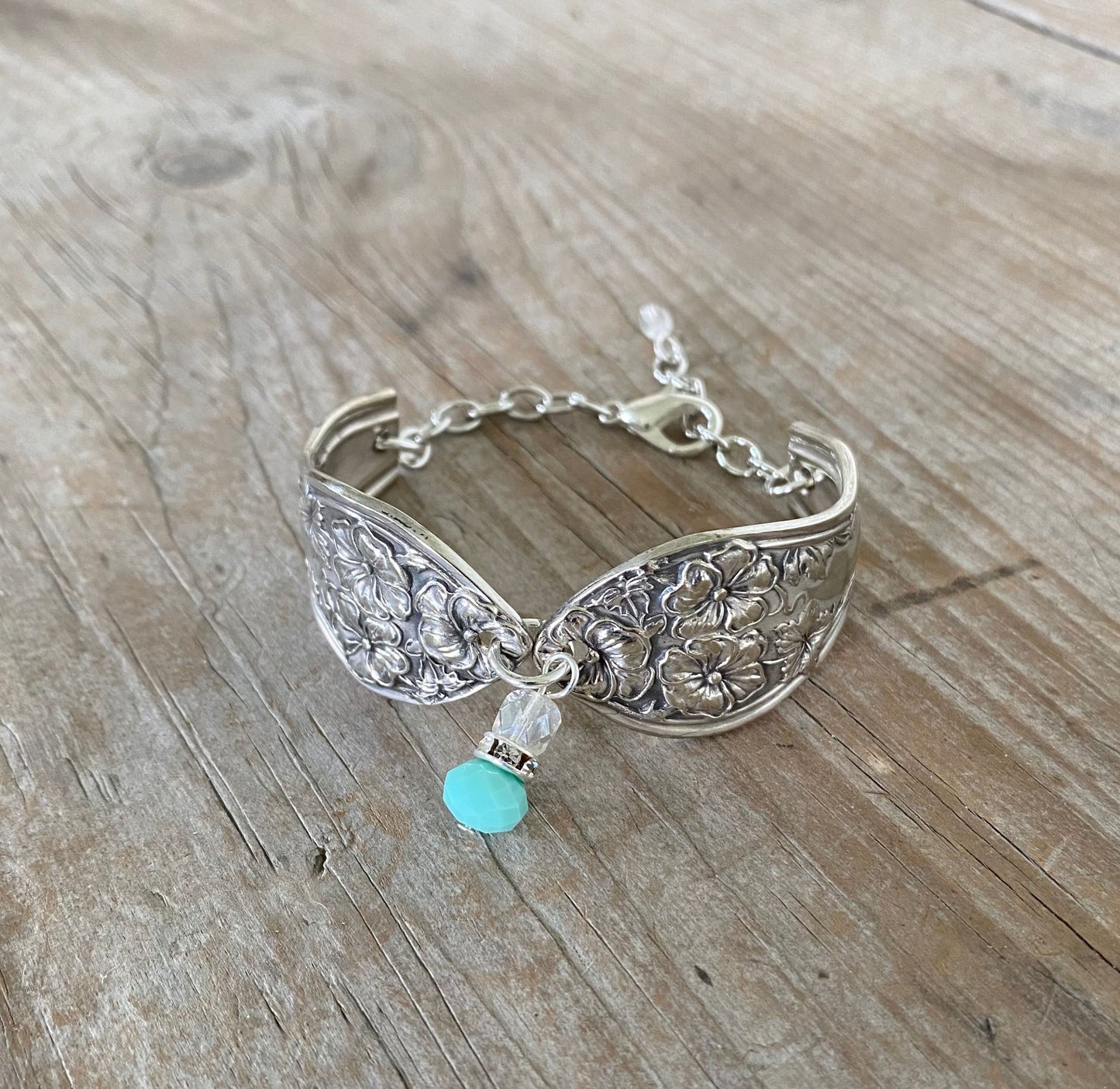 Close-up detail of 1913 Fairfield spoon links with jadeite bead and rhinestone spacer - handcrafted artisan silverware bracelet