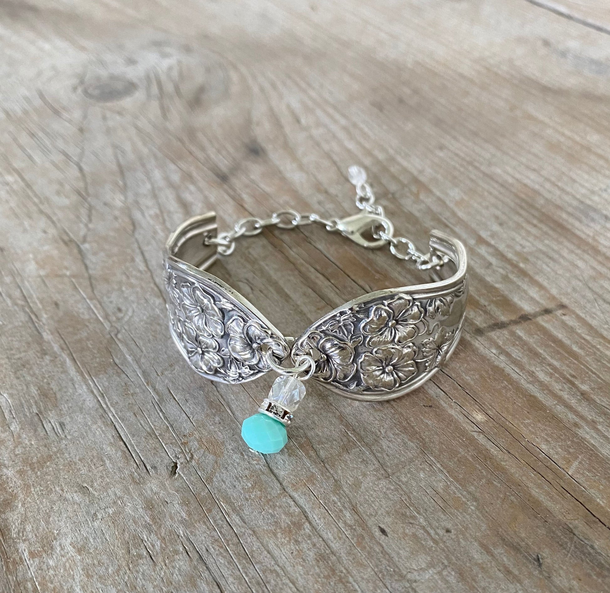Close-up detail of 1913 Fairfield spoon links with jadeite bead and rhinestone spacer - handcrafted artisan silverware bracelet