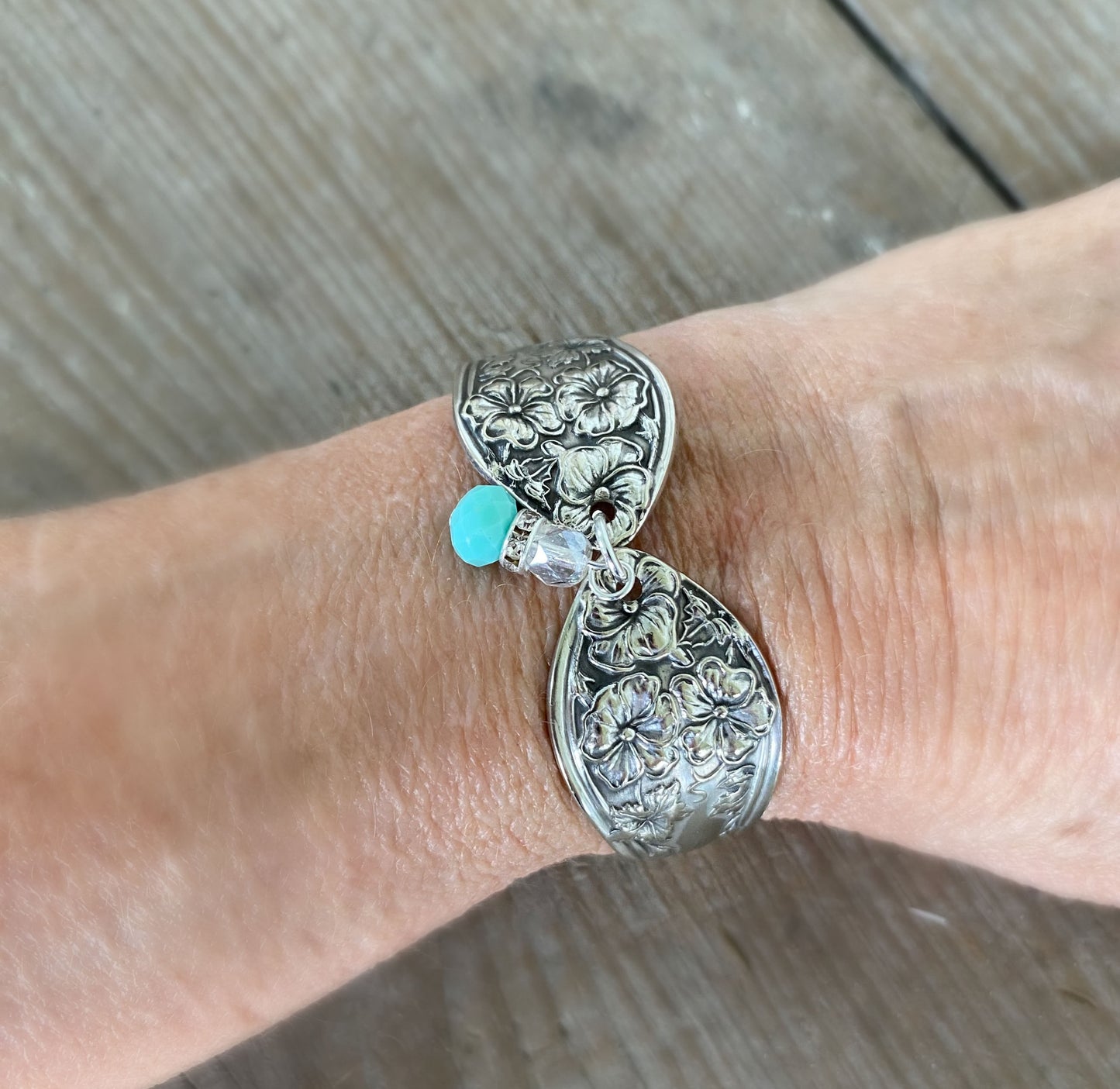 Fairfield spoon link bracelet with jadeite bead modeled on wrist - handcrafted upcycled 1913 vintage silverware jewelry