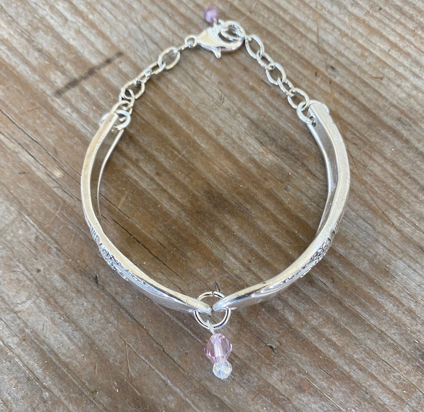 Top view of upcycled FIRST LOVE silverware link bracelet showing shape and clasp mechanism