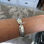FIRST LOVE spoon link bracelet worn on wrist displaying size and fit
