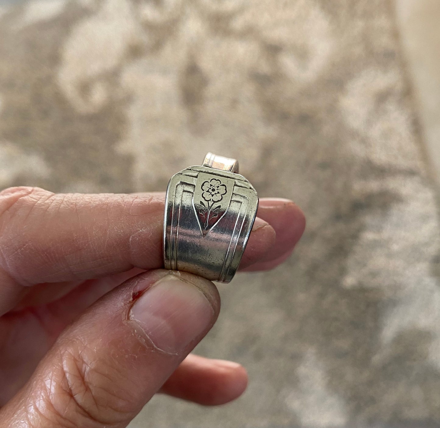 Detail of cute flower on handmade upcycled spoon ring 