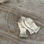 Close-up detail of handmade "Today's Catch" fish necklace crafted from vintage silverware spoon bowls with rose quartz - artisan upcycled jewelry