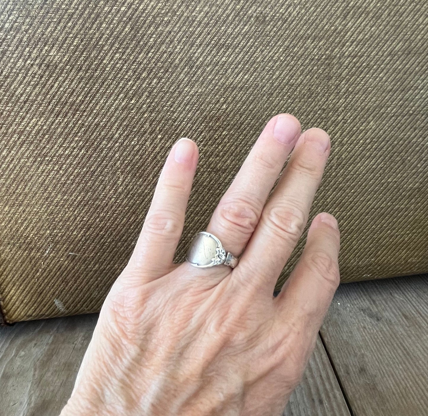 Mignonette sterling silver spoon ring shown on hand - handcrafted upcycled silverware jewelry