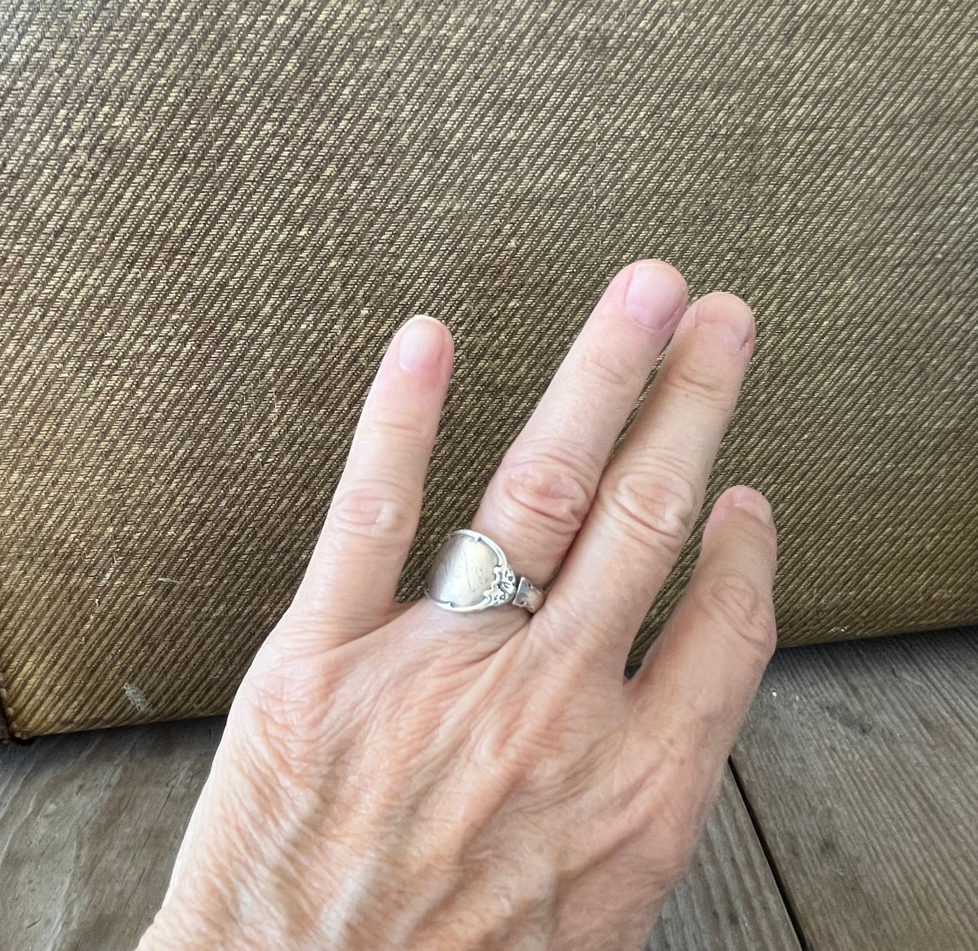 Mignonette sterling silver spoon ring shown on hand - handcrafted upcycled silverware jewelry