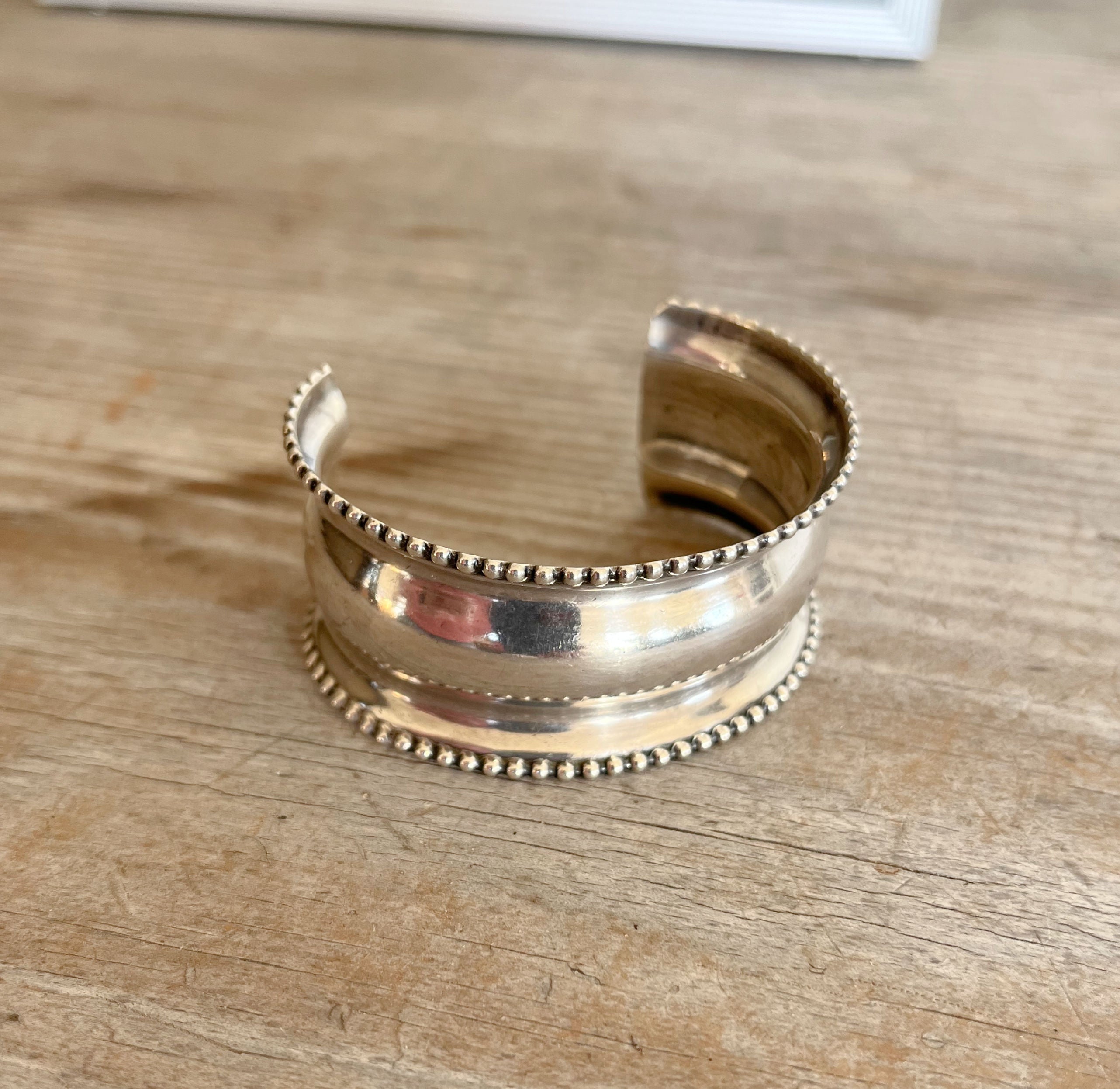 Antique sterling silver napkin ring cuff bracelet with finely dotted edge detail and curved contoured shape