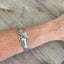 Sterling silver spoon link bracelet worn on wrist showing size and fit
