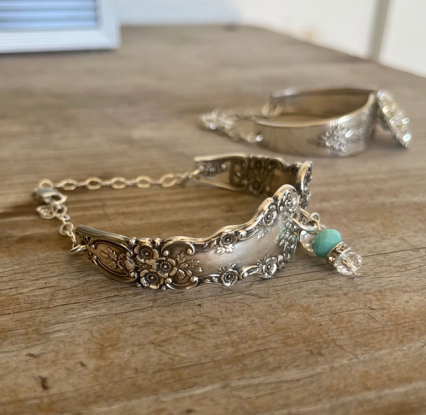 Close-up of Gorham Buttercup sterling silver spoon links showing detailed floral pattern