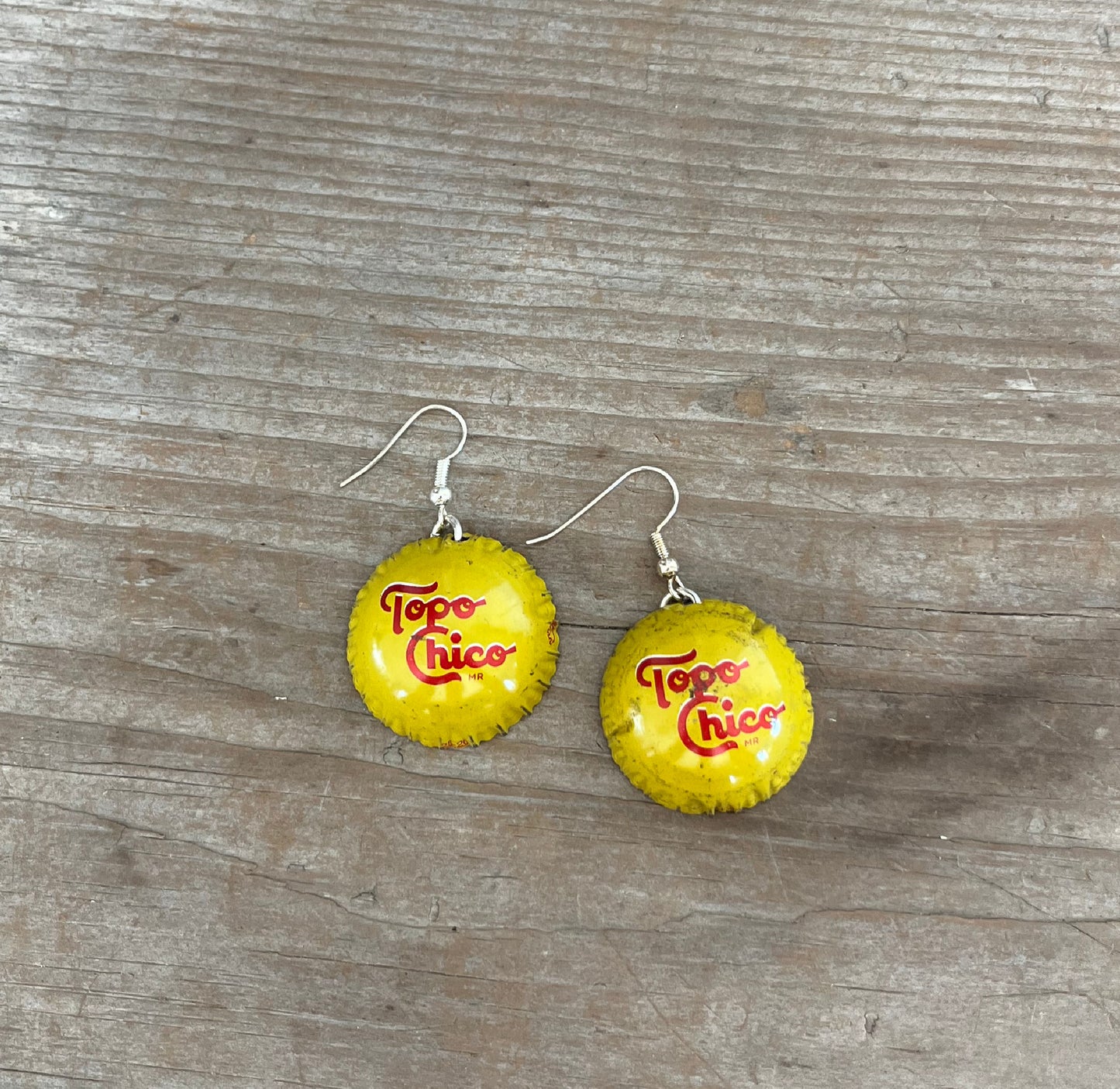 Handcrafted Topo Chico bottle cap earrings upcycled into colorful half-sphere design, one-of-a-kind jewelry