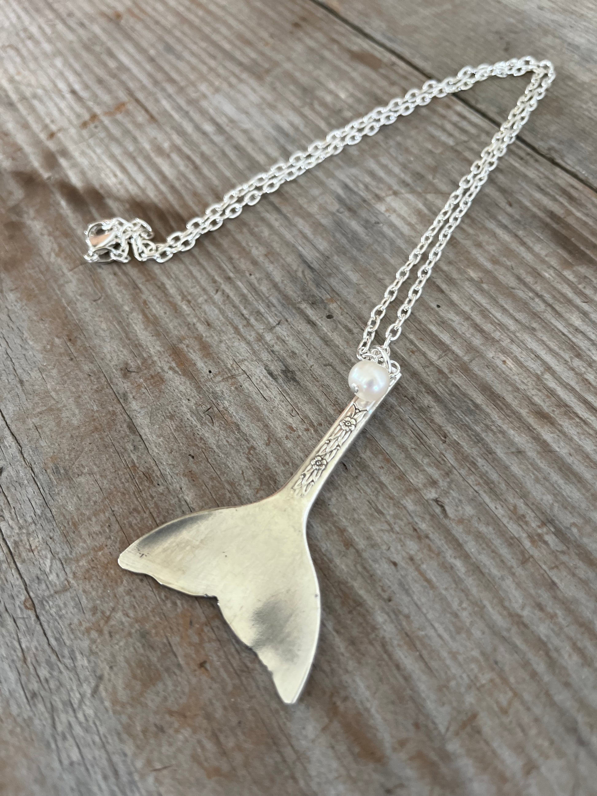Close-up of upcycled teaspoon mermaid tail pendant measuring 2-3/8 inches with large cultured pearl bead, handcrafted beach jewelry