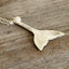 Side view of vintage silverplate spoon whale tail pendant on 23-inch chain showing cultured pearl and elegant drape, ocean jewelry
