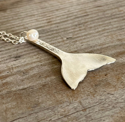 Side view of vintage silverplate spoon whale tail pendant on 23-inch chain showing cultured pearl and elegant drape, ocean jewelry