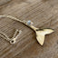Side view of upcycled spoon mermaid tail necklace with rhinestone sparkle bead on 20-inch silverplate chain, one-of-a-kind jewelry