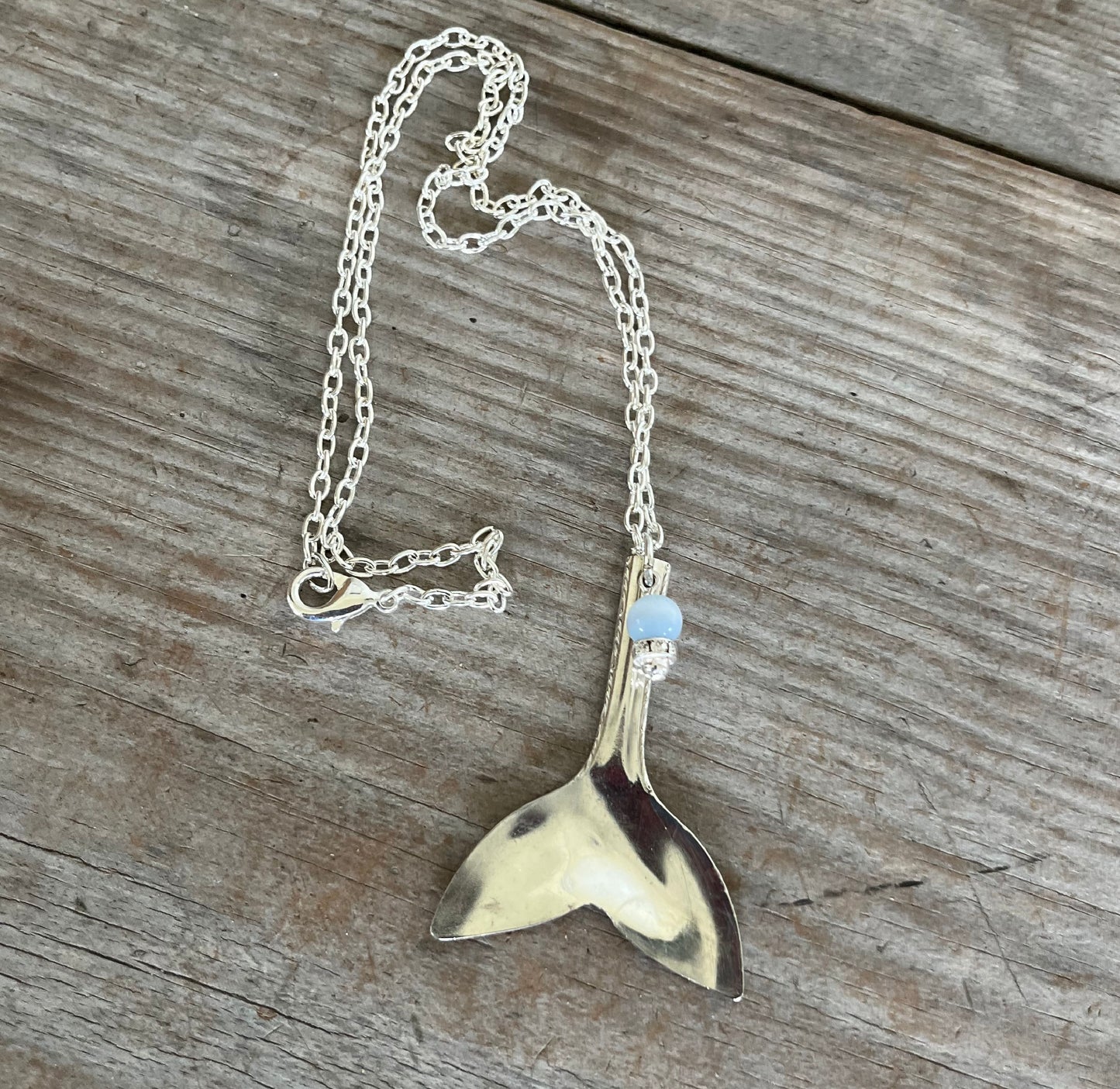 poon whale tail pendant measuring 2-1/4 inches, handcrafted from vintage teaspoon bowl with blue and rhinestone beads, beach jewelry