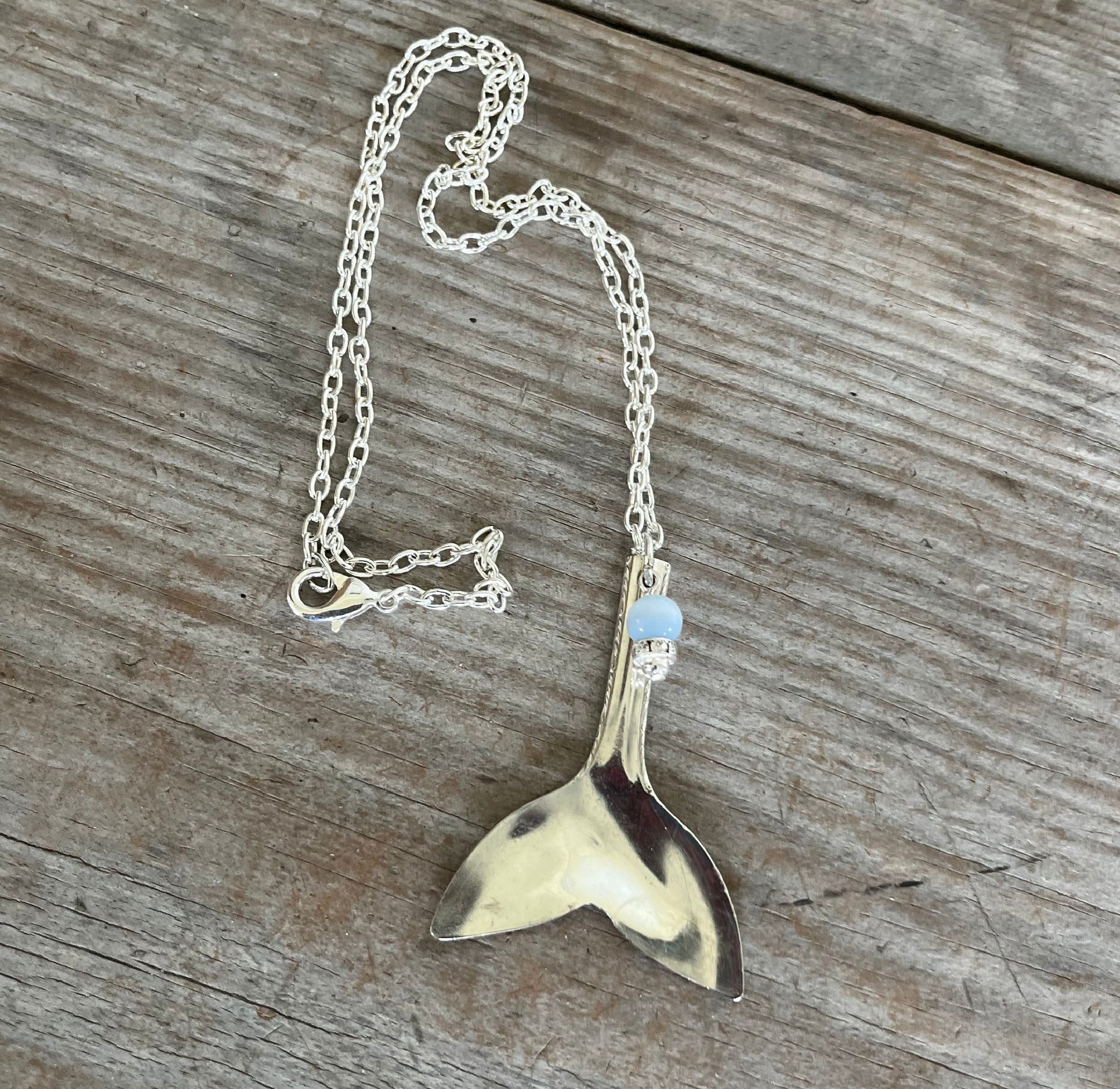 poon whale tail pendant measuring 2-1/4 inches, handcrafted from vintage teaspoon bowl with blue and rhinestone beads, beach jewelry