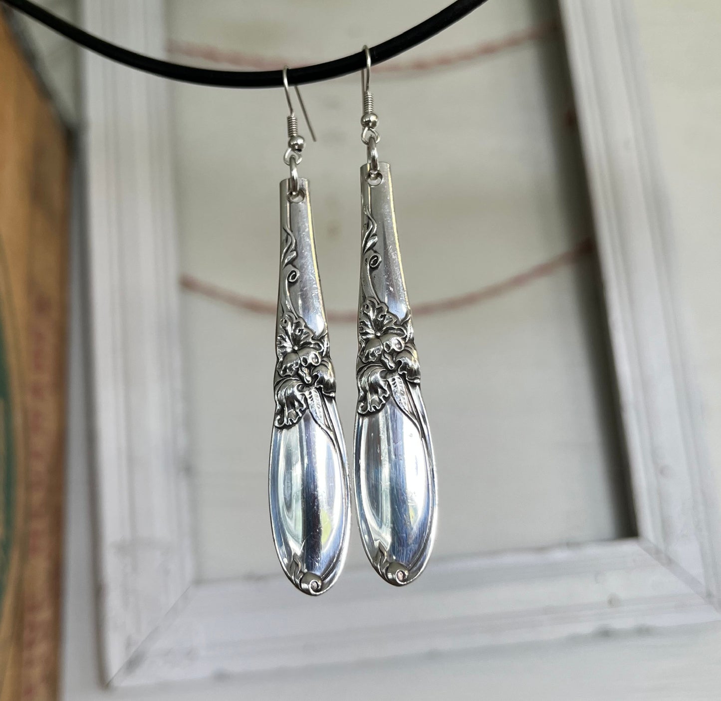 Close-up detail of iconic orchid floral design on White Orchid spoon handle earrings, one-of-a-kind 1953 pattern