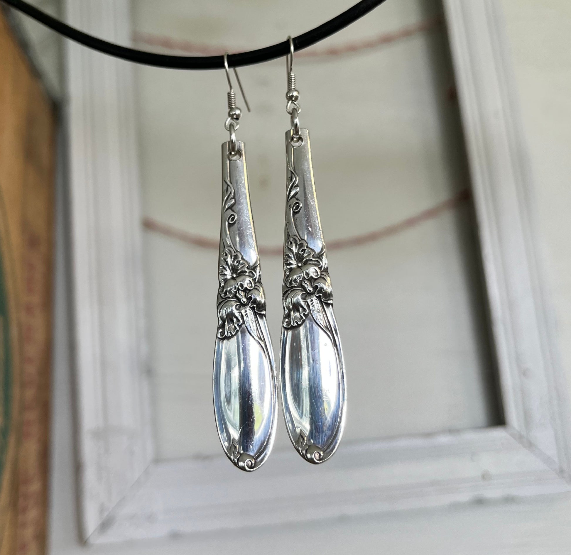 Close-up detail of iconic orchid floral design on White Orchid spoon handle earrings, one-of-a-kind 1953 pattern