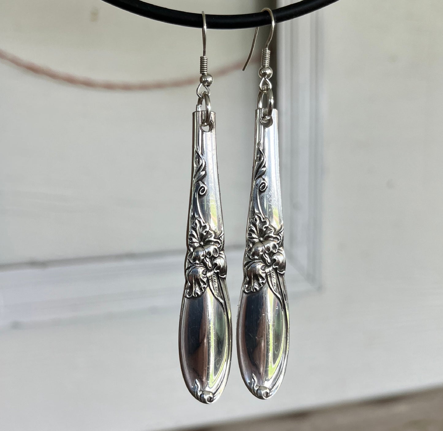 White Orchid spoon earrings showing classic midcentury floral flair and detail