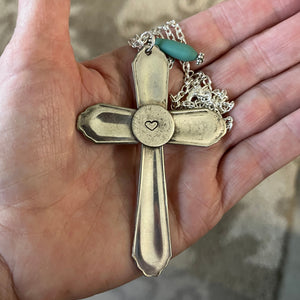 Spoon Necklace with Cross Pendant with Heart on Back Shown in Hand for scale