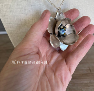 Handmade Sculptural Spoon Flower Necklace Pendant Shown in hand for scale