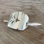 Close-up of vintage cake server barrette showing elegant pierced cutouts and spoon stick detail