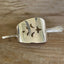 Vintage cake server hair barrette close-up showing pierced cutout detail
