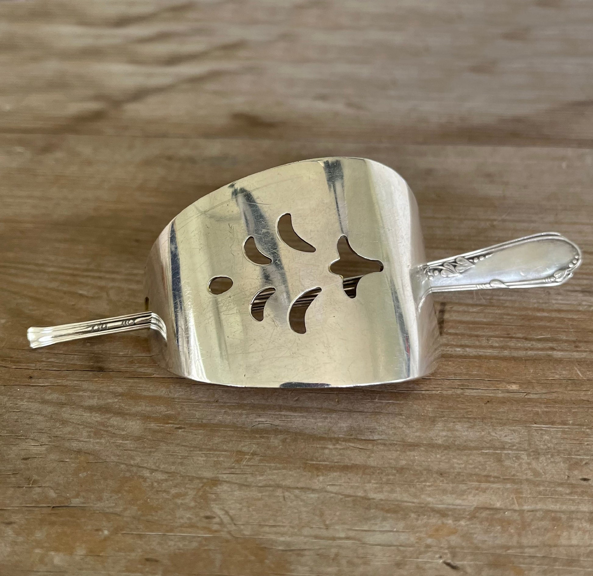 Vintage cake server hair barrette close-up showing pierced cutout detail