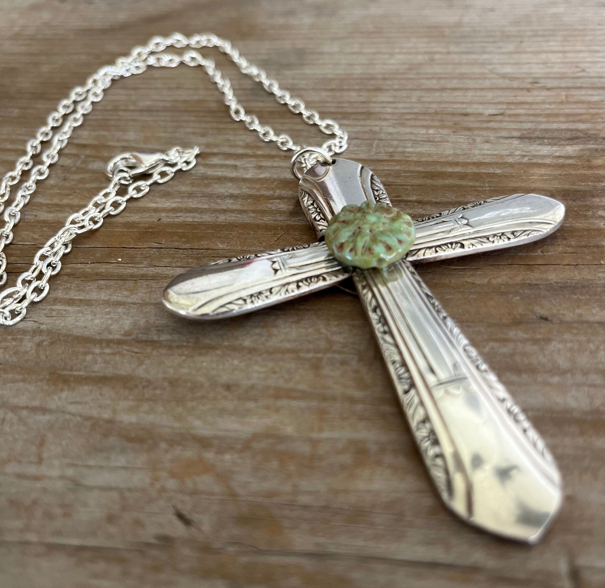Close-up of unique Regent pattern cross pendant with green-turquoise floral bead - upcycled vintage silverplate statement piece