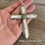 Vintage 1939 William Rogers Regent spoon handles transformed into artisan cross pendant shown in hand for scale