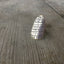 Close-up of artistic hand-stamped design on statement spoon bowl ring