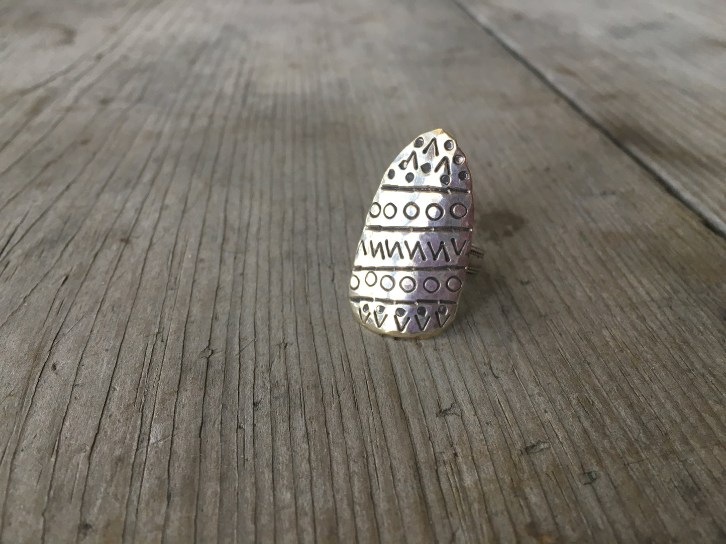 Close-up of artistic hand-stamped design on statement spoon bowl ring