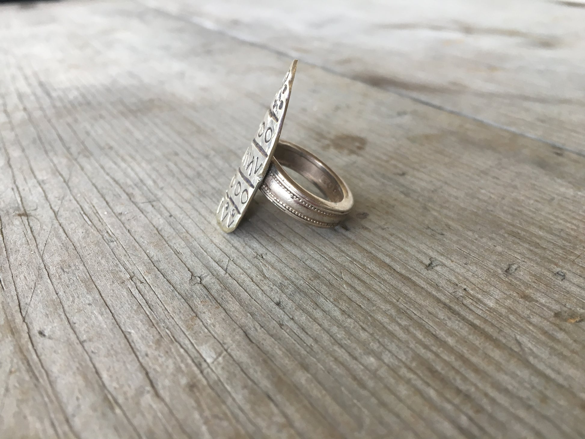Side close-up of stamped art statement spoon ring - handcrafted upcycled silverware