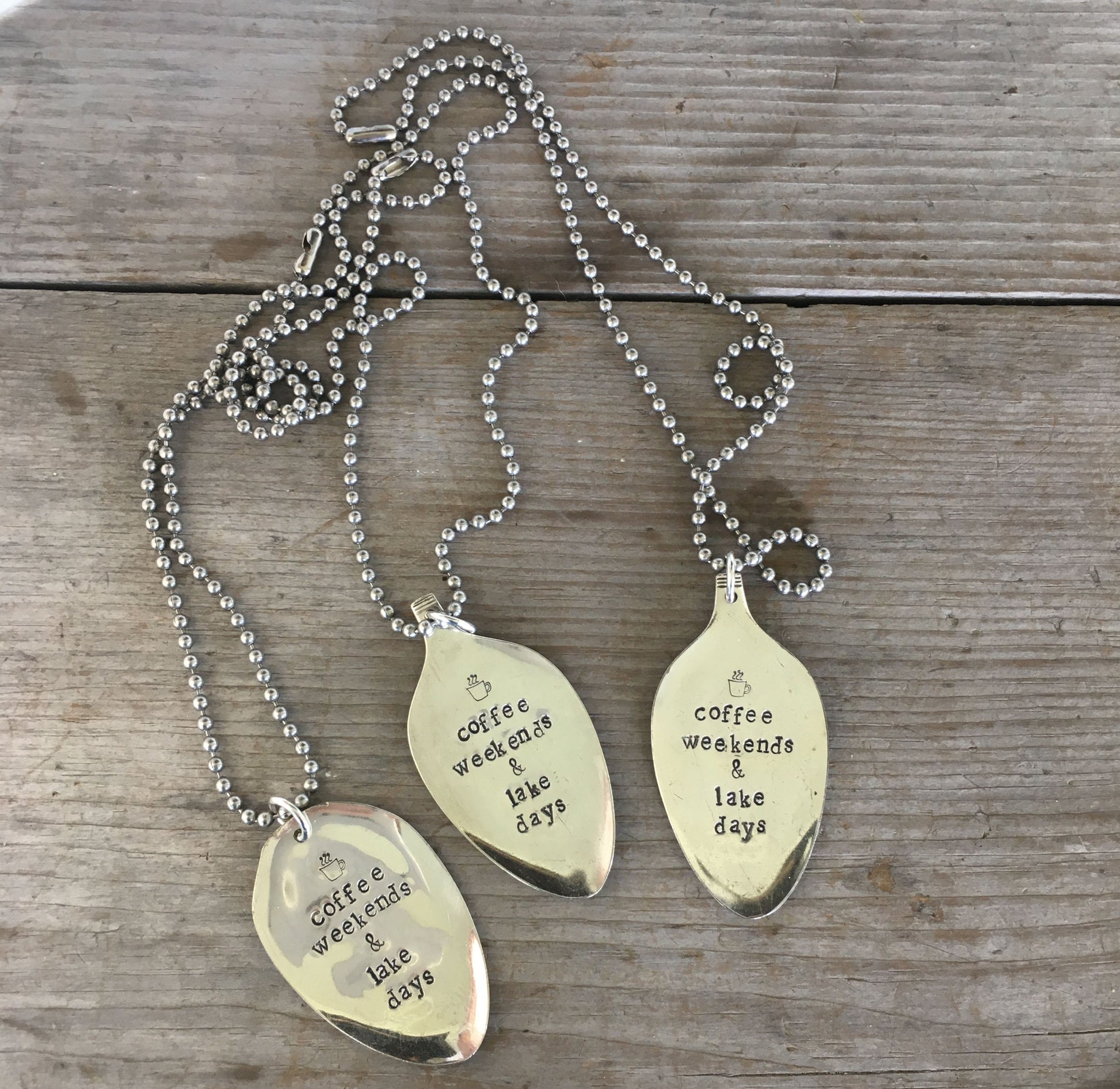 Multiple COFFEE WEEKENDS & LAKE DAYS stamped spoon necklaces showing handcrafted variations, lake life theme