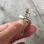 Detail of handcrafted Yvonne spoon ring showing antique silverplate patina and artisan metalwork of the shank and the top