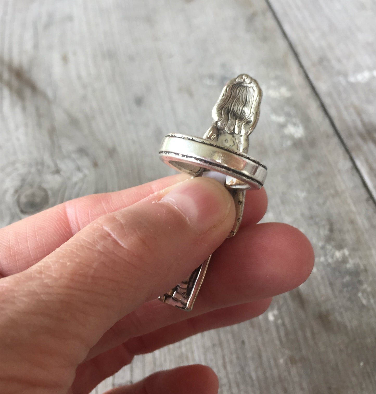 Detail of handcrafted Yvonne spoon ring showing antique silverplate patina and artisan metalwork of the shank and the top
