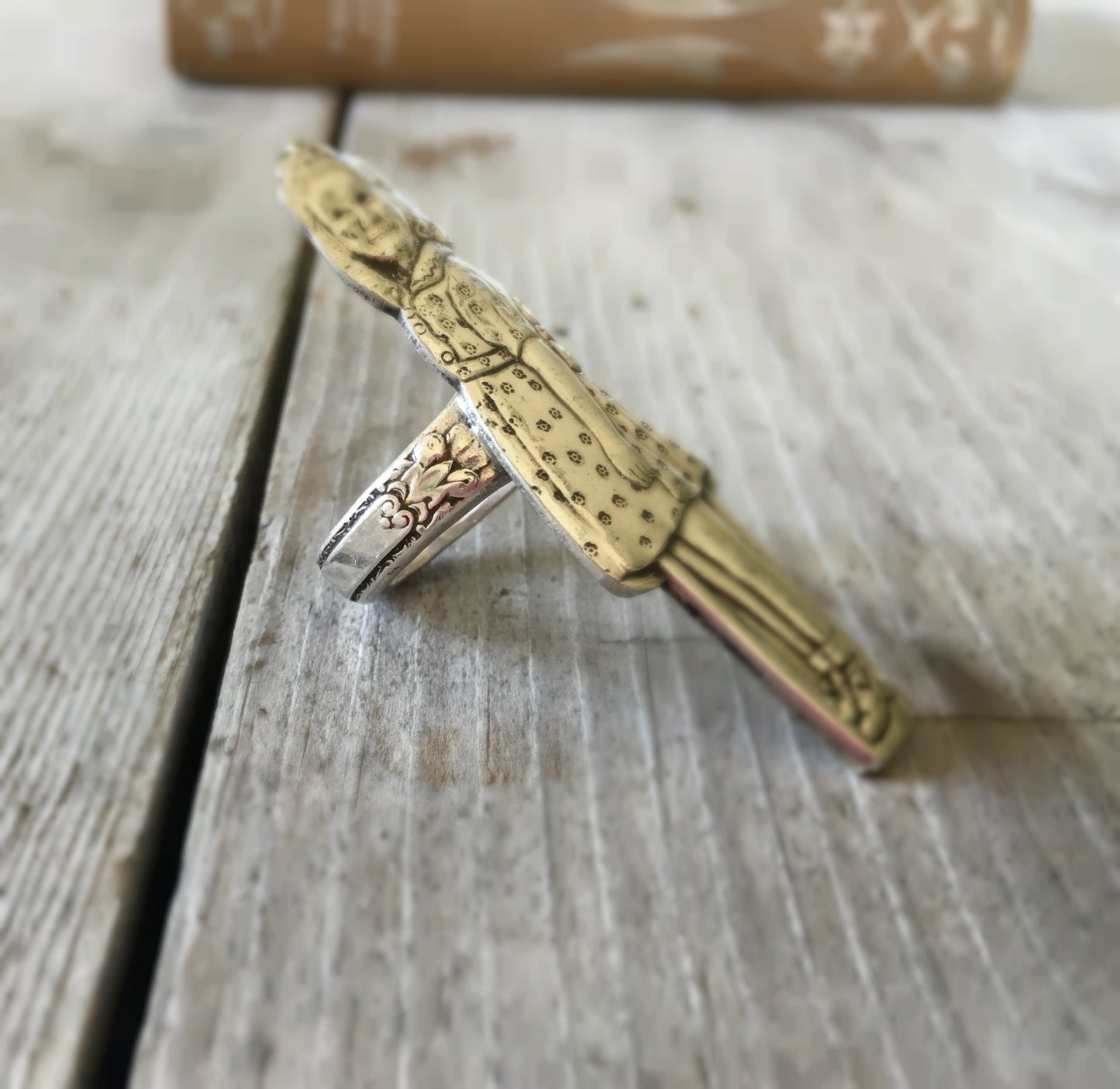 Side view of upcycled vintage spoon ring featuring Dionne quintuplet commemorative silverware
