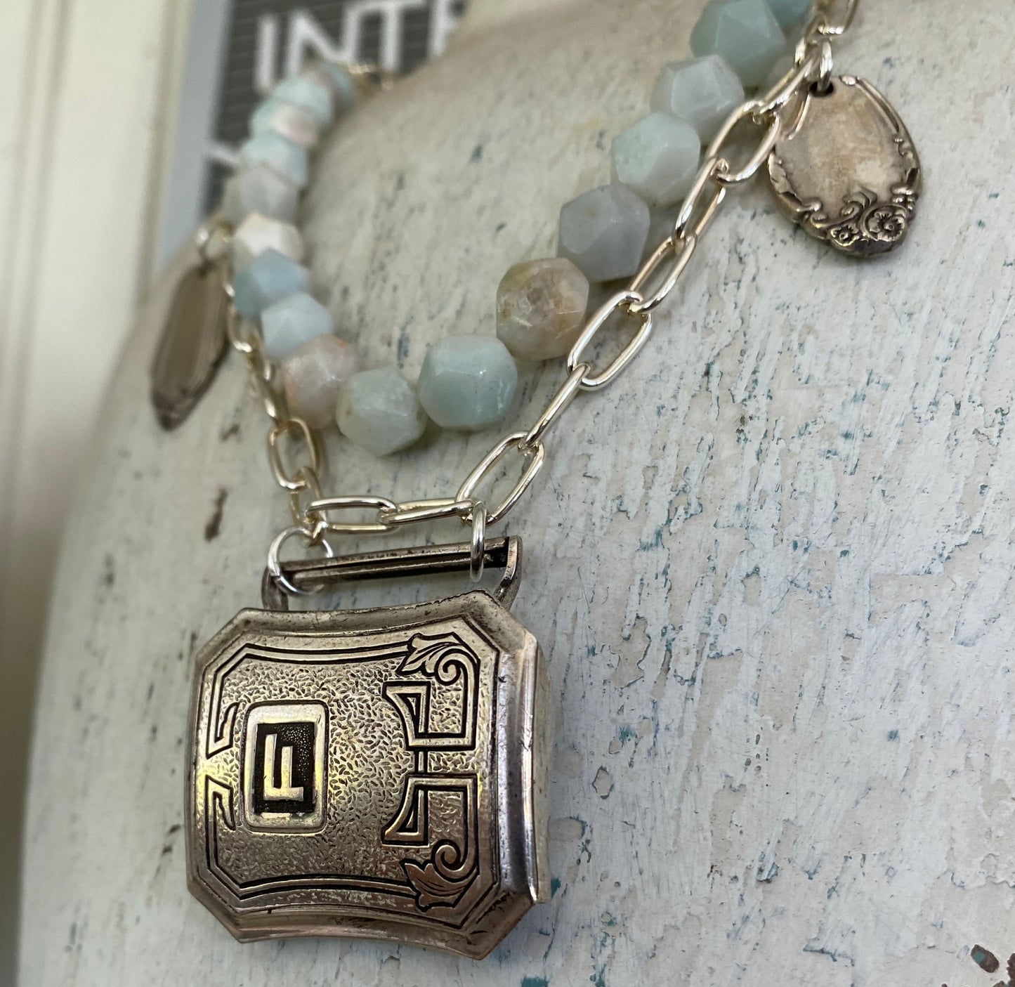 Detailed view of handmade belt buckle necklace with turquoise magnesite beads and vintage silverware bits - eco-friendly jewelry