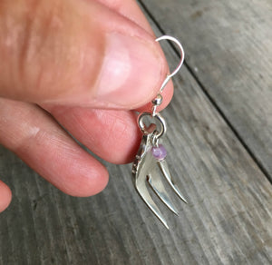 Close up of cocktail fork earring