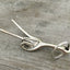Side view of Key chain upcycled from a fork into the shape of a hand give the peace sign hand gesture