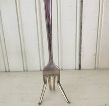 Back view of hand stamped upcycled fork easel